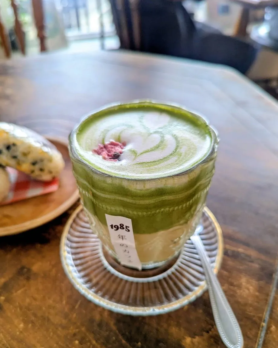 Matcha latte with a dried sakura flower